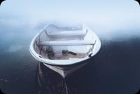 Lonely Boat On A Lake With Foggy Background